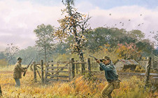 Hunter aims rifle over a fence in tall grass near trees on a cloudy day.