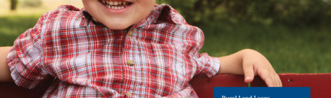 Smiling toddler in red plaid shirt outdoors with educational text.