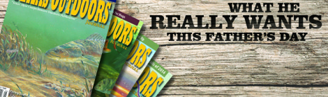 Colorful magazines titled "Outdoors" fanned out on a wooden table with text about dads and fathers.