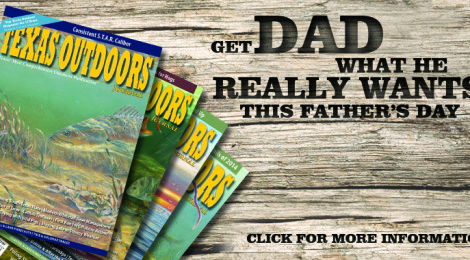 Colorful magazines titled "Outdoors" fanned out on a wooden table with text about dads and fathers.