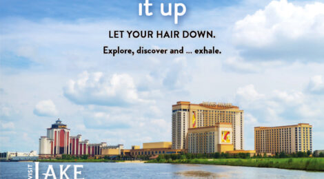 Kayakers enjoy Lake Charles with city skyline views on a clear day.