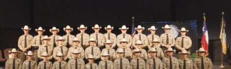 Group of uniformed officers on stage.